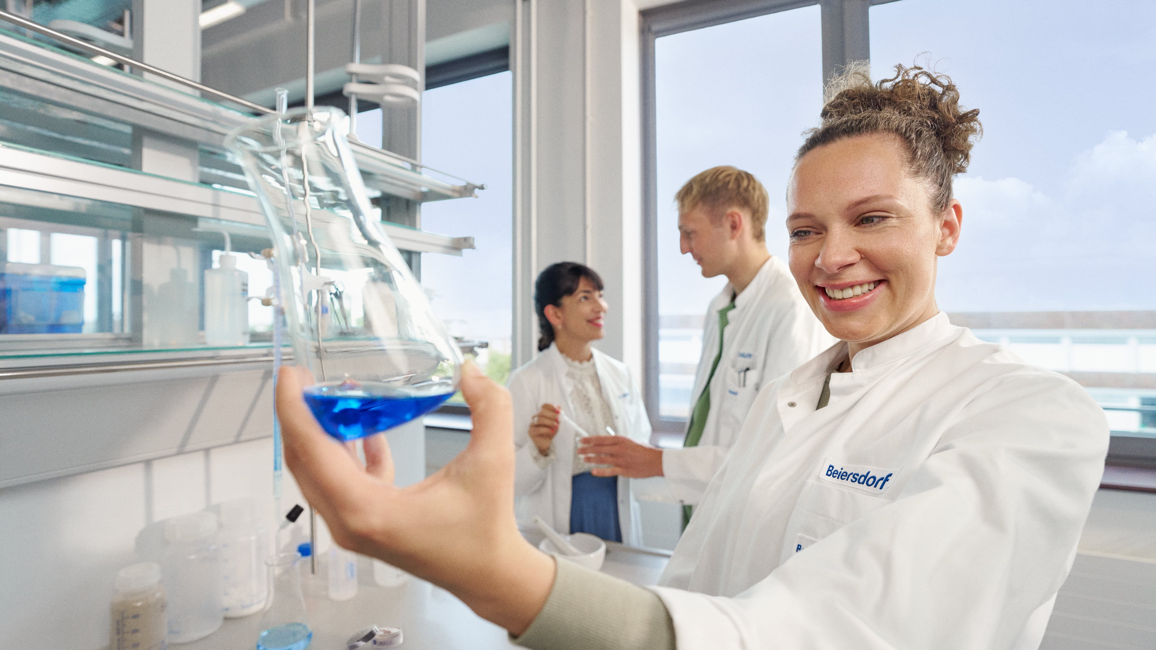 Three colleagues in a lab conducting innovative research.